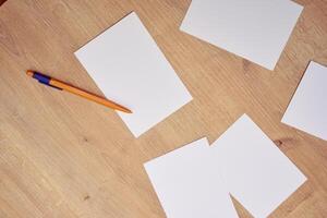 blank a 4 paper and a pen on a table photo