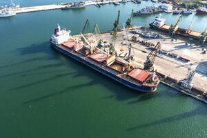 Aerial view from a drone of a large ship loading grain for export. Water transport photo