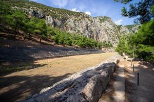 Ancient Stadium, Delphi, UNESCO World Heritage Site. Famous Archaeological site in Greece. God of Appollo temple. View of the ancient amphitheater. photo