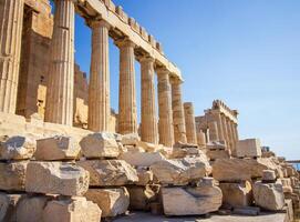 Ancient Parthenon Temple on top of the Acropolis Athens, Greece at sunny day with a blue sky. The landmark of Athens. Parthenon is the temple of for dedication to the goddess Athena. photo