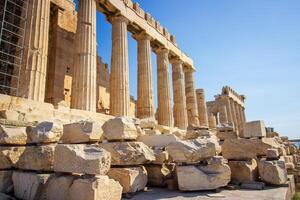 Ancient Parthenon Temple on top of the Acropolis Athens, Greece at sunny day with a blue sky. The landmark of Athens. Parthenon is the temple of for dedication to the goddess Athena. photo