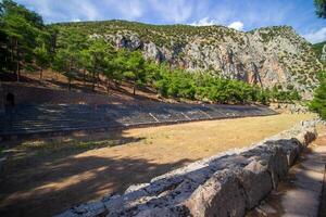 Ancient Stadium, Delphi, UNESCO World Heritage Site. Famous Archaeological site in Greece. God of Appollo temple. View of the ancient amphitheater. photo