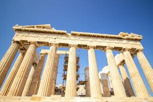 Ancient Parthenon Temple on top of the Acropolis Athens, Greece at sunny day with a blue sky. The landmark of Athens. Parthenon is the temple of for dedication to the goddess Athena. photo