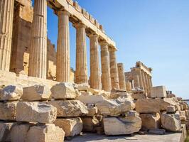 Ancient Parthenon Temple on top of the Acropolis Athens, Greece at sunny day with a blue sky. The landmark of Athens. Parthenon is the temple of for dedication to the goddess Athena. photo