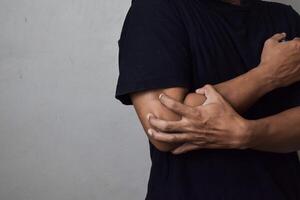View of man scratching hand with allergy isolated on beige background photo