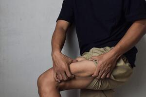 Cellulite skin problem, fat thigh overweight men on beige background photo