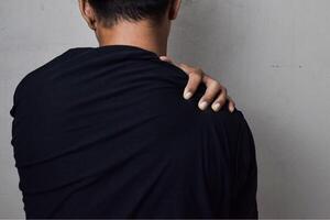 Man itching on shoulder. Medical and healthcare concept photo