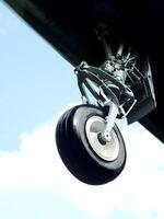 Close up of a landing gear of an airplane in the air. Airplane tire. Air transportation photo