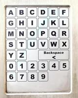 close up of a metal keypad number and alphabet on a public facility. unclean metal object photo