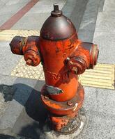 dry hydrants for fire fighting. The hydrant is yellow with some rust and vandalism. public facilities that need maintenance photo