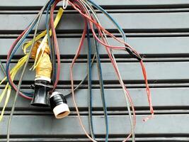 messy electric power cables installation. chaotic network of a tangled electrical wires. Unsightly electric wires on public area causing danger to health and safety. photo