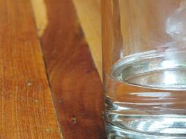 close up of a Glass of water on wooden table background. copy space for text. Refreshment concept idea photo