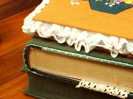stack of old vintage books isolated on wooden table background photo