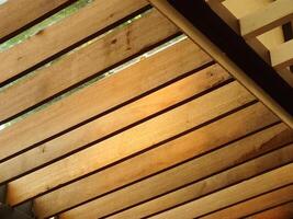 A timber roof truss with geometric wooden patterns. Architectural background concept housing photo