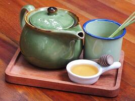 tea cup and teapot set on wooden table. relaxing moment at tea time routine photo