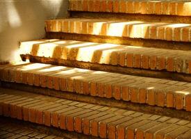 Old red brick stairs with sun rays around it. Path way concept background with copy space for text photo