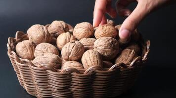 hand pick natural walnuts from a bowl video
