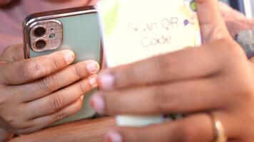 woman hand using the smart phone to scan the qr code to select food menu in the restaurant video