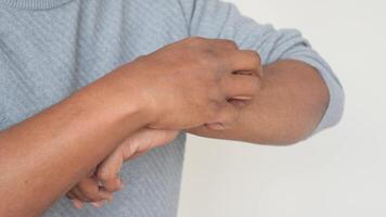 man suffering from itching skin, close up. video