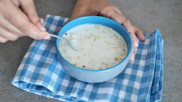 healthy breakfast with oats flakes and banana on table , top down . video