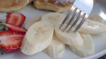 closeup of fork pick slice of a banana video