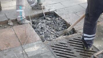 Using a hammer to break through bedrock for landscaping event video