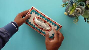 hand pull out a piece of tissue from tissue paper box video