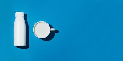 A bottle and a mug with milk photo