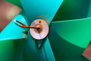 Close-up of plastic green Pinwheel in amusement park. Abstract Background of ornament in amusement park. Graphic Resources. Macro Photography. Travel Destinations. Holiday photography concept photo