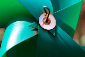 Close-up of plastic green Pinwheel in amusement park. Abstract Background of ornament in amusement park. Graphic Resources. Macro Photography. Travel Destinations. Holiday photography concept photo