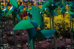 Close-up of plastic green Pinwheel in amusement park. Abstract Background of ornament in amusement park. Graphic Resources. Macro Photography. Travel Destinations. Holiday photography concept photo