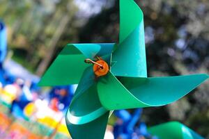 Close-up of plastic green Pinwheel in amusement park. Abstract Background of ornament in amusement park. Graphic Resources. Macro Photography. Travel Destinations. Holiday photography concept photo