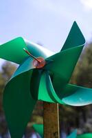 Close-up of plastic green Pinwheel in amusement park. Abstract Background of ornament in amusement park. Graphic Resources. Macro Photography. Travel Destinations. Holiday photography concept photo