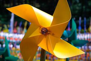 Close-up of plastic Yellow Pinwheel in amusement park. Abstract Background of ornament in amusement park. Graphic Resources. Macro Photography. Travel Destinations. Holiday photography concept photo