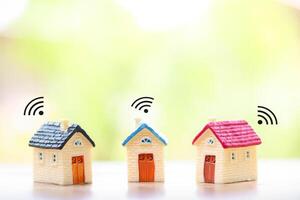 Miniature house with Wifi signal. The concept of network connect, internet of things, smart home control and automation system technology photo