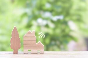 Miniature house with Wifi signal. The concept of network connect, internet of things, smart home control and automation system technology photo