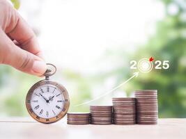 Vintage watch and stack of coins with arrow rising up. The concept of saving money for manage time to success business in year 2025. photo
