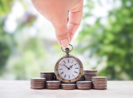 Vintage watch on stack of coins. The concept of saving money for manage time to success business. photo