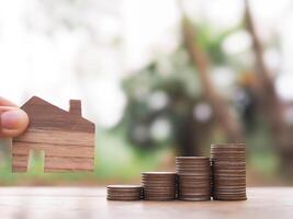 Miniature house and stack of coins. The concept of saving money for house, Property investment, House mortgage, Real estate photo