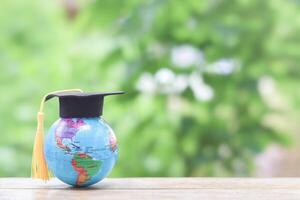 Earth globe with graduation hat. Copy space for text, Back to school, Education concept photo