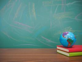 Student creative desktop with earth globe on hardcover book. Copy space for text, Back to school, Education concept photo
