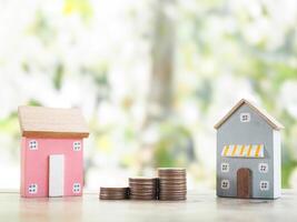 Miniature house and stack of coins. The concept of saving money for house, Property investment, House mortgage, Real estate photo