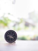 Close up compass on table in the sunset time. The concept of world tourism day, Searching the right directions and Travel photo
