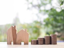Miniature house and stack of coins. The concept of saving money for house, Property investment, House mortgage, Real estate photo