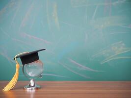 Glass earth globe with graduation hat. Copy space for text, Back to school, Education concept photo