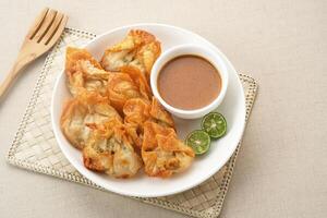 Batagor, made from fish or chicken dumpling, tofu, tapioca flour served with peanut sauce. Indonesian food photo