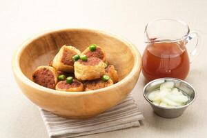 Gohyong or Ngo Hiang, made from minced chicken with flour, served with sour sauce photo