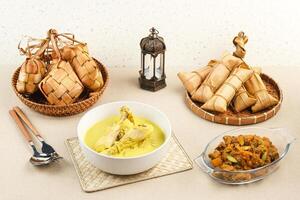 Opor Ayam, served with ketupat and sambal goreng ati. Popular during Eid al Fitr. Indonesian traditional food photo