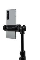 Smartphone mounted on a tripod. Stable photo or shooting for a blog or social media content. Isolate on a white back.