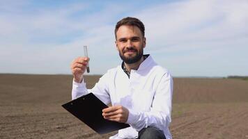 Scientist studying sample of soil in field video